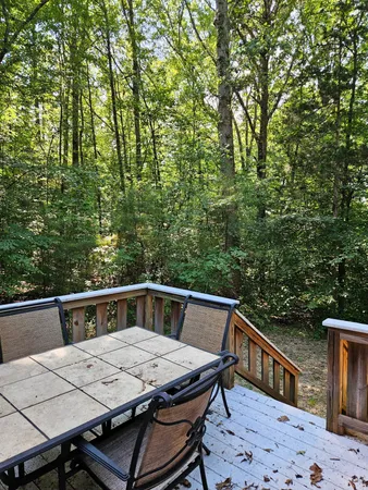 a view of backyard with a table and chairs