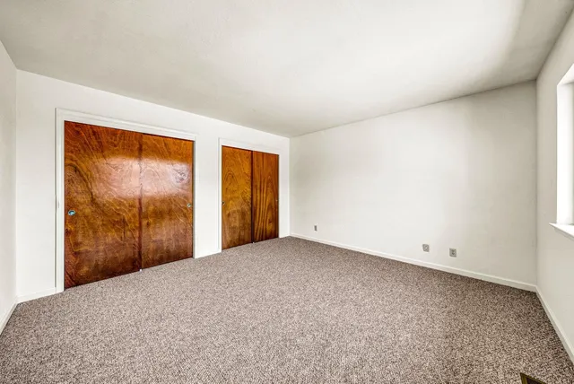 a view of a dining room with furniture and a kitchen