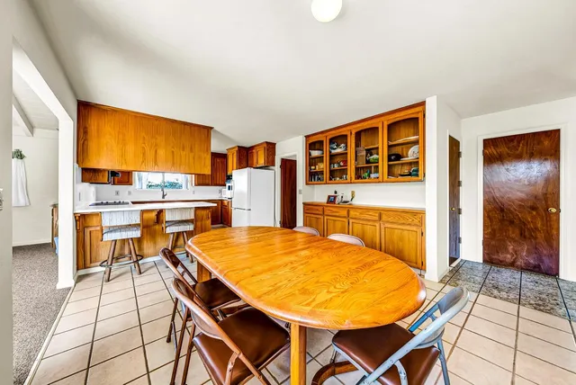 a view of a room with gym equipment and a chandelier