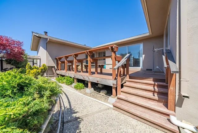 a front view of a building with a garden