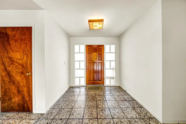 a view of a bathroom with wooden floor and a window