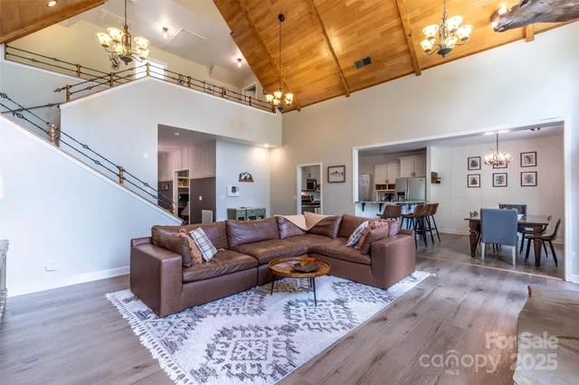 a living room with furniture dining area and a chandelier