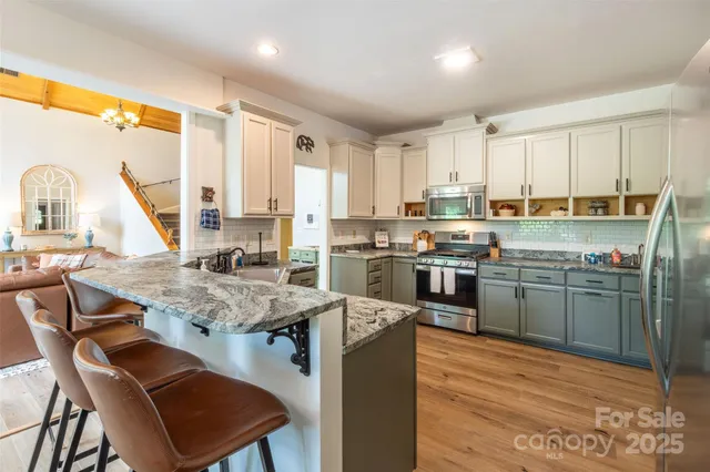a kitchen with a stove a sink a counter top space and appliances