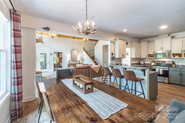 a living room with dining room and kitchen view