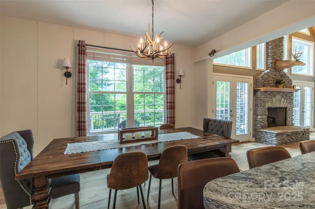 a view of a dining room with furniture a chandelier and wooden floor
