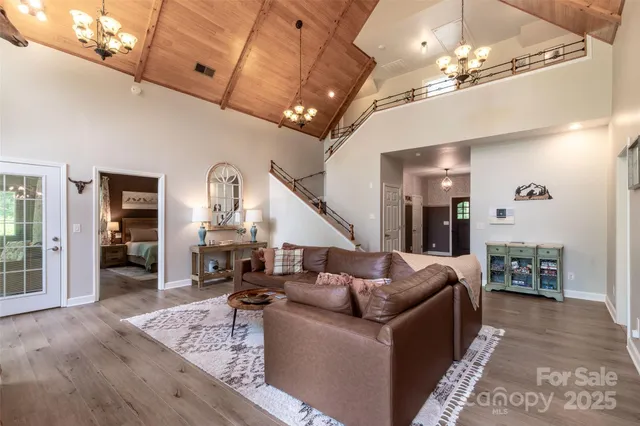 a living room with furniture and a chandelier