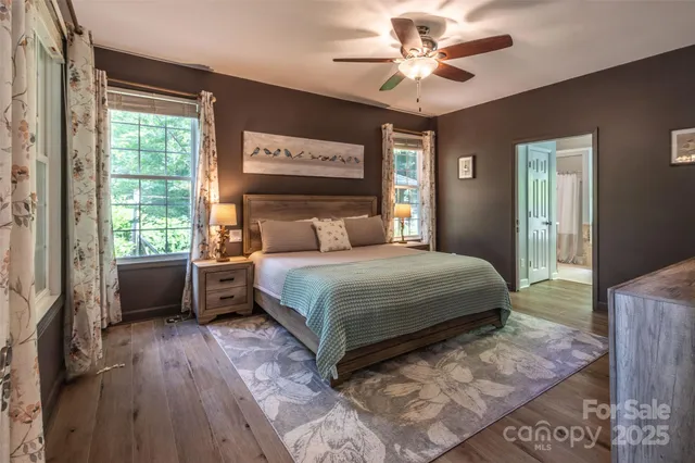 a bedroom with a bed dresser and a window