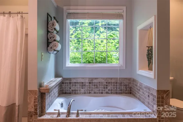 a bathroom with a bathtub and shower