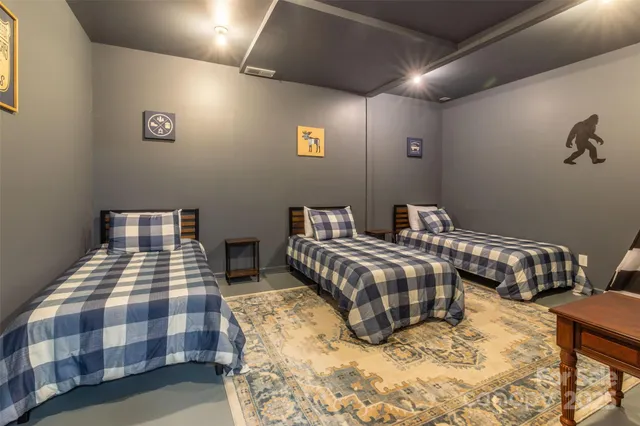 a bedroom with two beds and painted walls