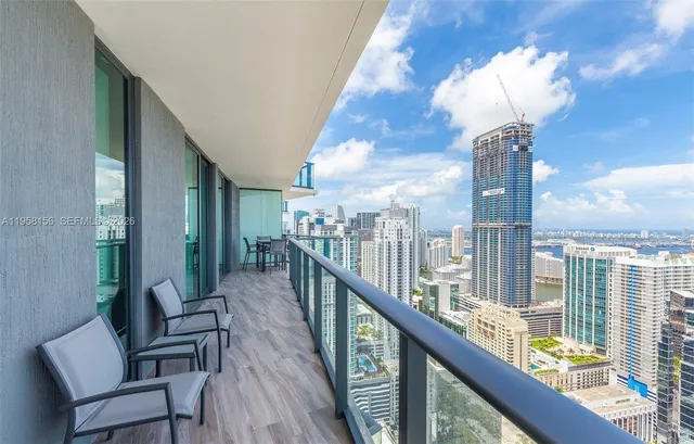 a view of a balcony with wooden chairs