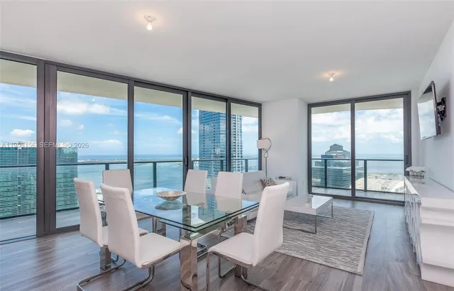 a living room with furniture and large windows