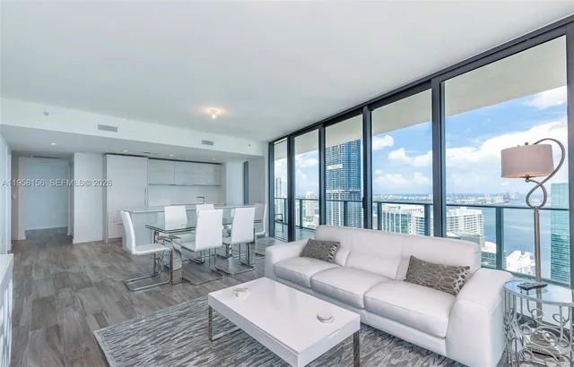 a living room with furniture and a large window