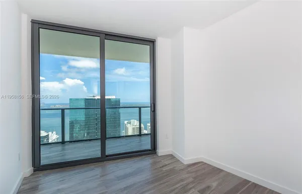 an empty room with wooden floor and a window