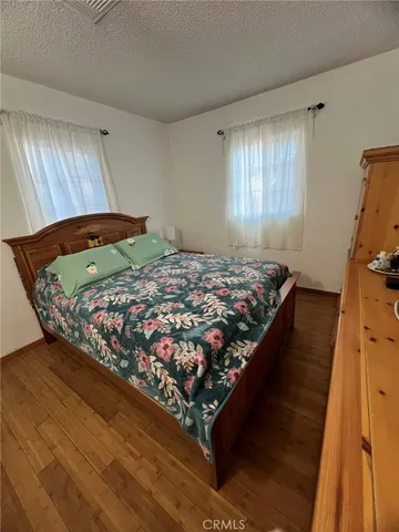 a bed sitting in a bedroom next to a window