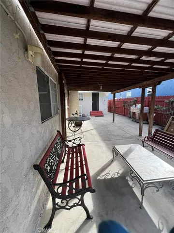 a backyard of a house with barbeque oven table and chairs
