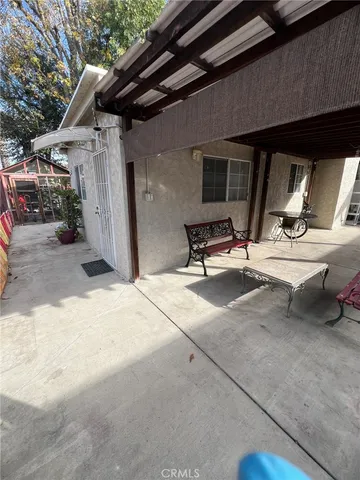 a building outdoor space with patio furniture and a ceiling fan