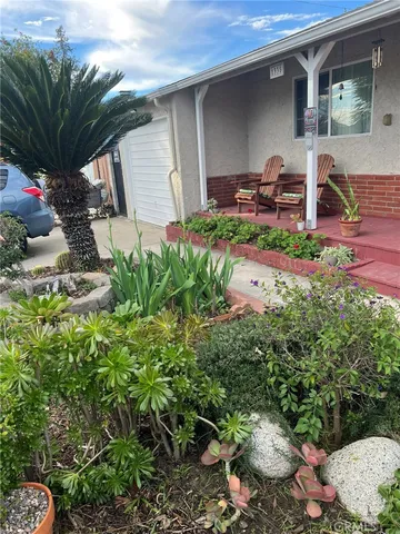 a backyard of a house with table and chairs