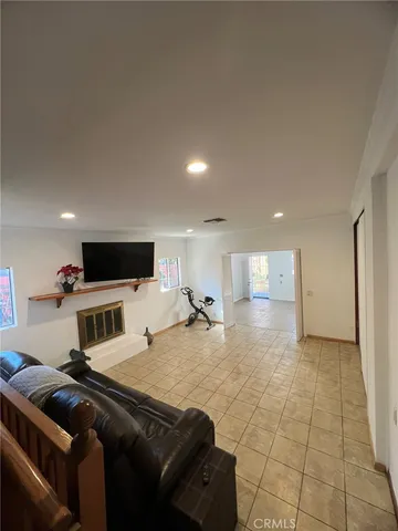 a bedroom with a bed and a television