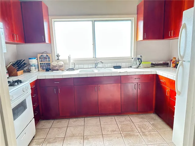 a kitchen with a sink a bath tub and a window