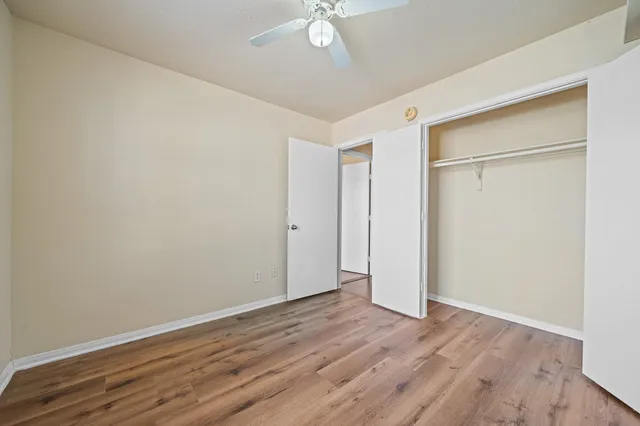a view of an empty room with wooden floor