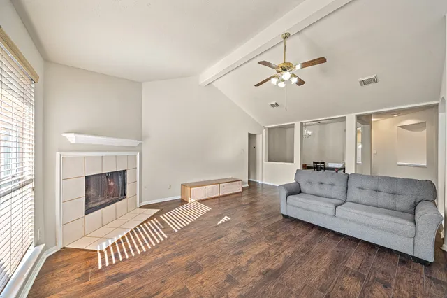 a living room with furniture and a fireplace