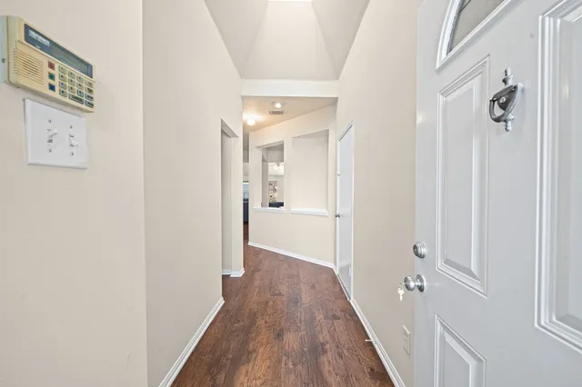 a view of a hallway with wooden floor