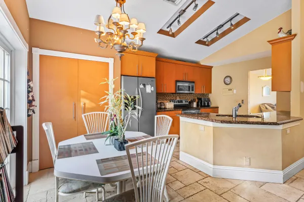 a view of a dining room with furniture wooden floor and a chandelier