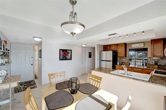 a living room with furniture kitchen view and a chandelier