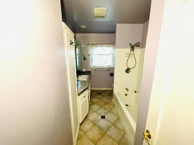 a bathroom with a sink and mirror