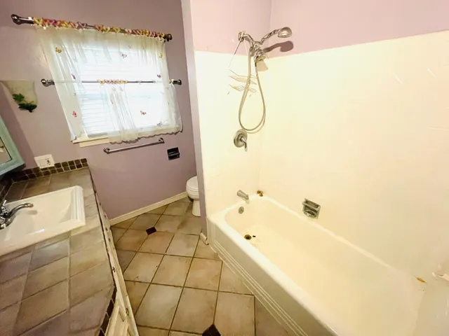 a bathroom with a bathtub and shower