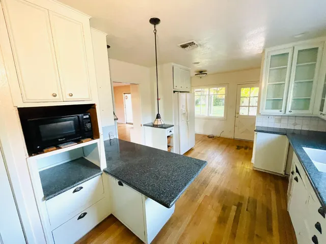 a kitchen with a stove a sink and a microwave