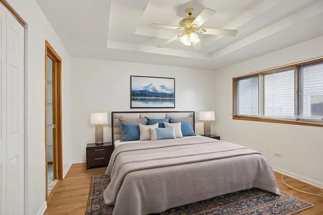 a bedroom with a large bed and a chandelier