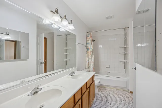 a bathroom with a sink a large mirror and shower