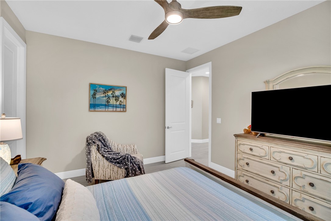 105 Night Hawk Way Sebastian, FL 32958 - Photo 25 of 36 a bedroom with furniture and a flat screen tv