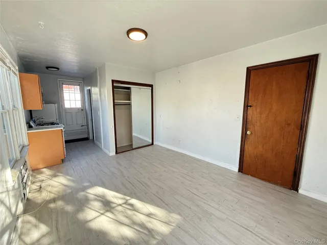 a view of a room with an entryway and wooden floor