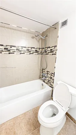a bathroom with a toilet and a bathtub