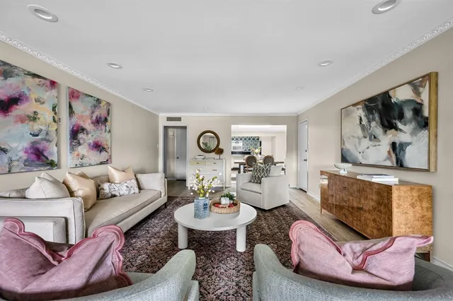 a living room with furniture and wall paintings