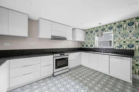 a kitchen with stainless steel appliances granite countertop a sink stove and cabinets