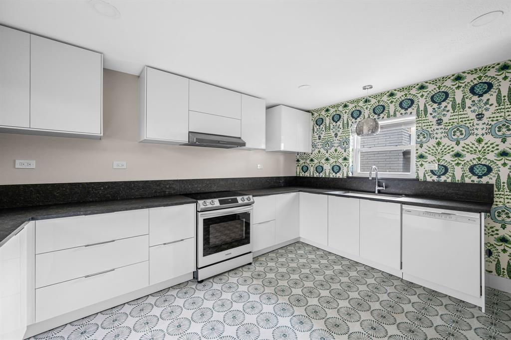 6226 Bandera Avenue, Unit C Dallas, TX 75225 - Photo 7 of 19 a kitchen with granite countertop white cabinets and white appliances