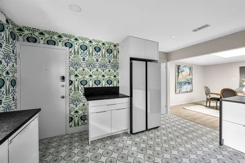 a kitchen with stainless steel appliances a stove a sink and a refrigerator