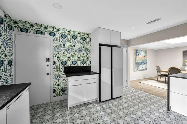 a kitchen with stainless steel appliances a stove a sink and a refrigerator