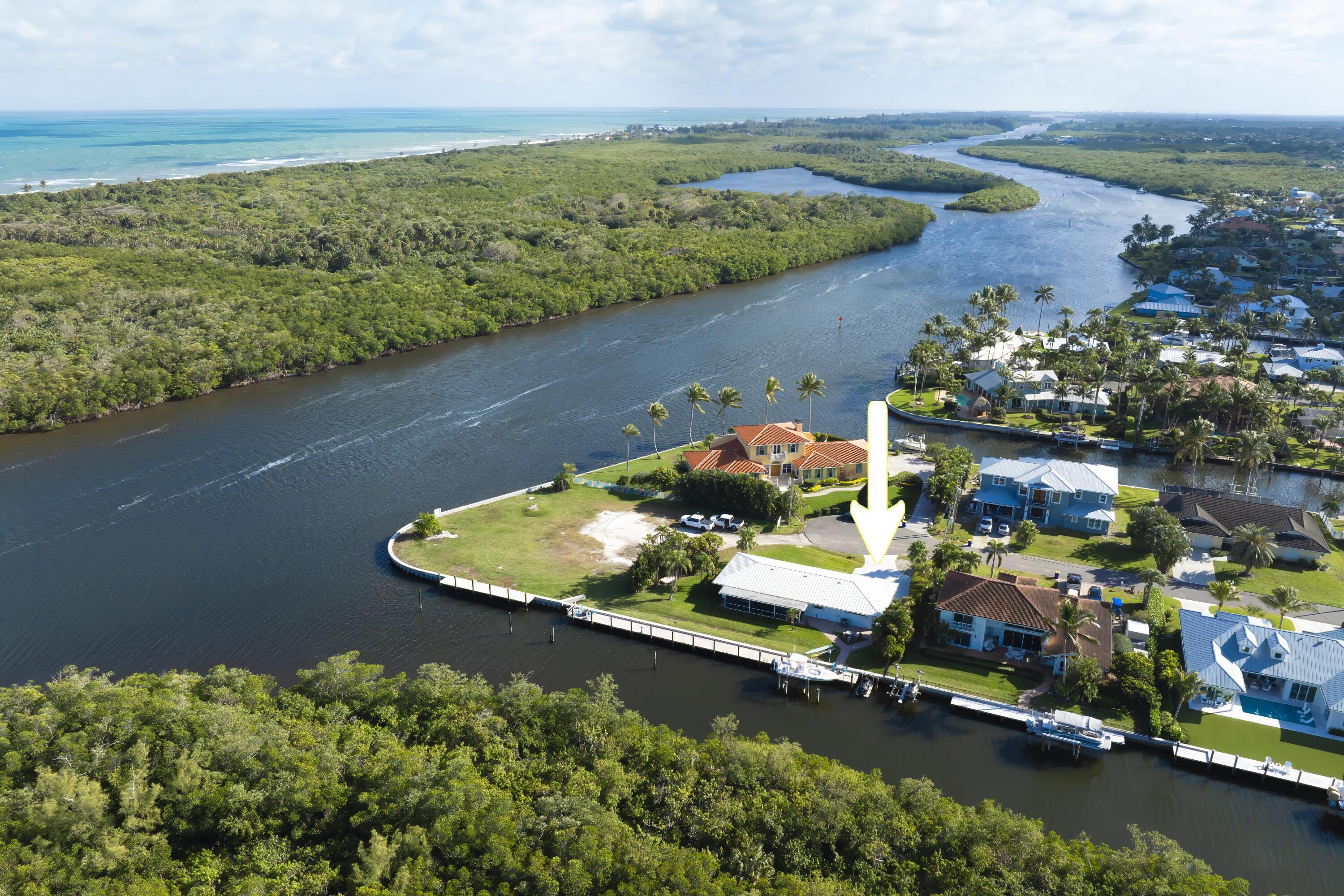 8585 Southeast Palm Street Hobe Sound, FL 33455 - Photo 1 of 43 an aerial view of lake residential houses with outdoor space