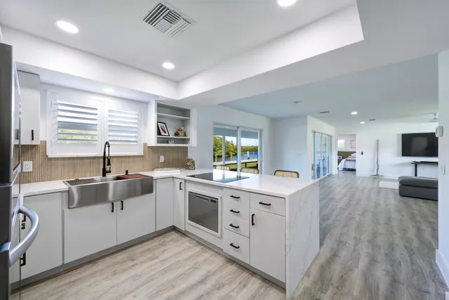 a kitchen with a sink stove and cabinets
