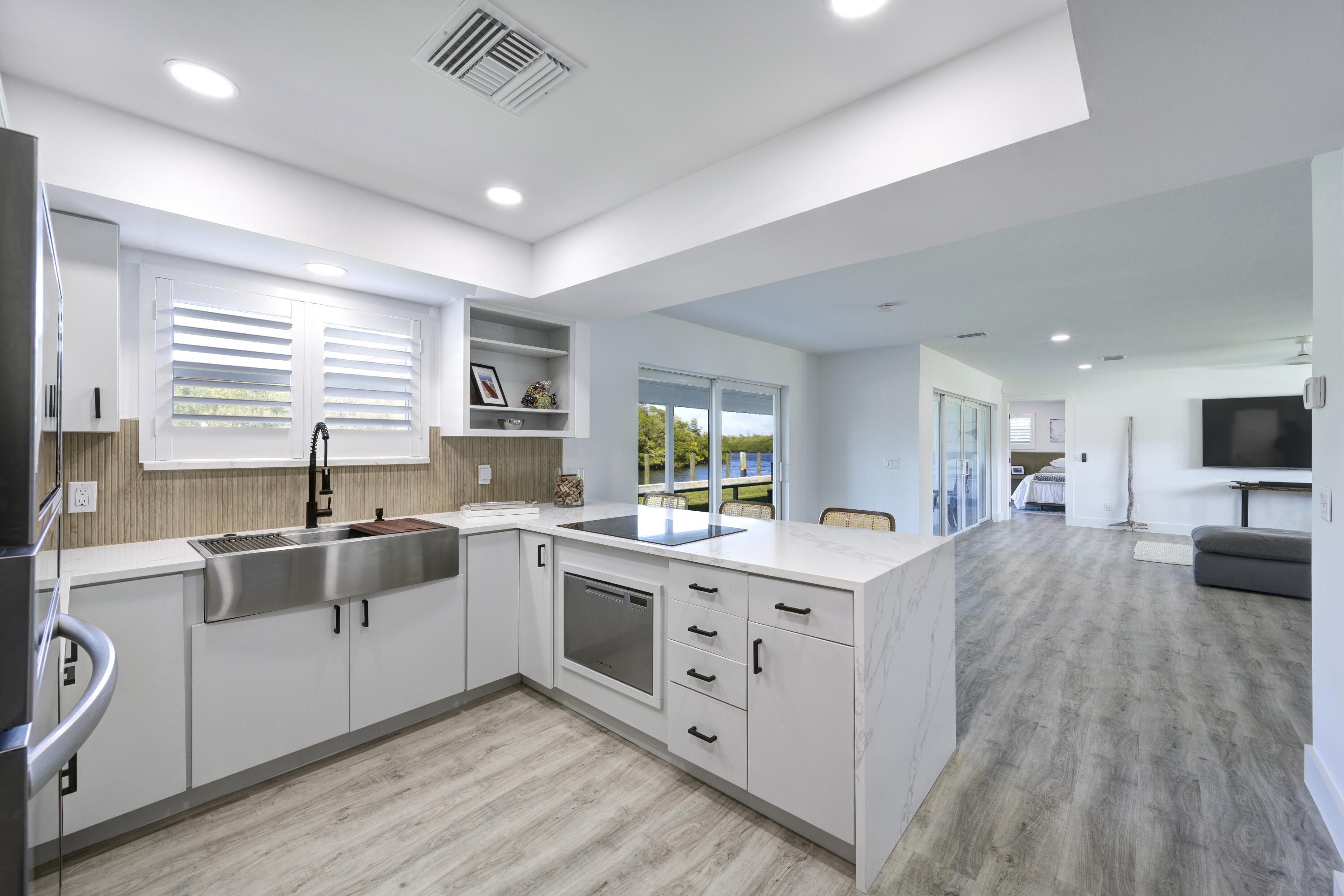 8585 Southeast Palm Street Hobe Sound, FL 33455 - Photo 14 of 43 a kitchen with a sink stove and cabinets