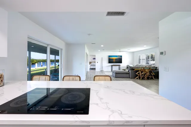 a living room with furniture a flat screen tv and a large window