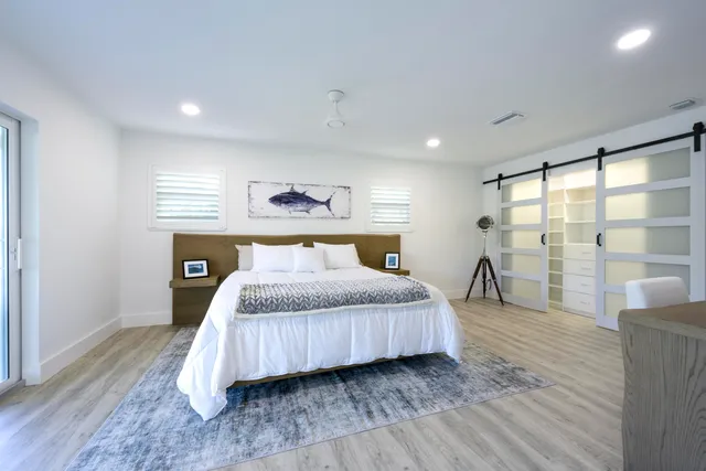 a bedroom with a large bed and a large window