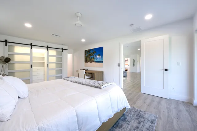 a spacious bedroom with a large bed and a large window