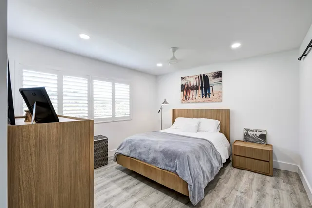 a bedroom with a large bed and a window