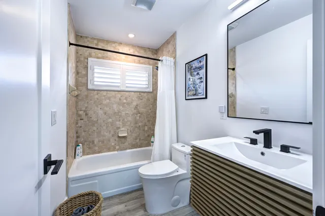 a bathroom with a sink toilet and bathtub