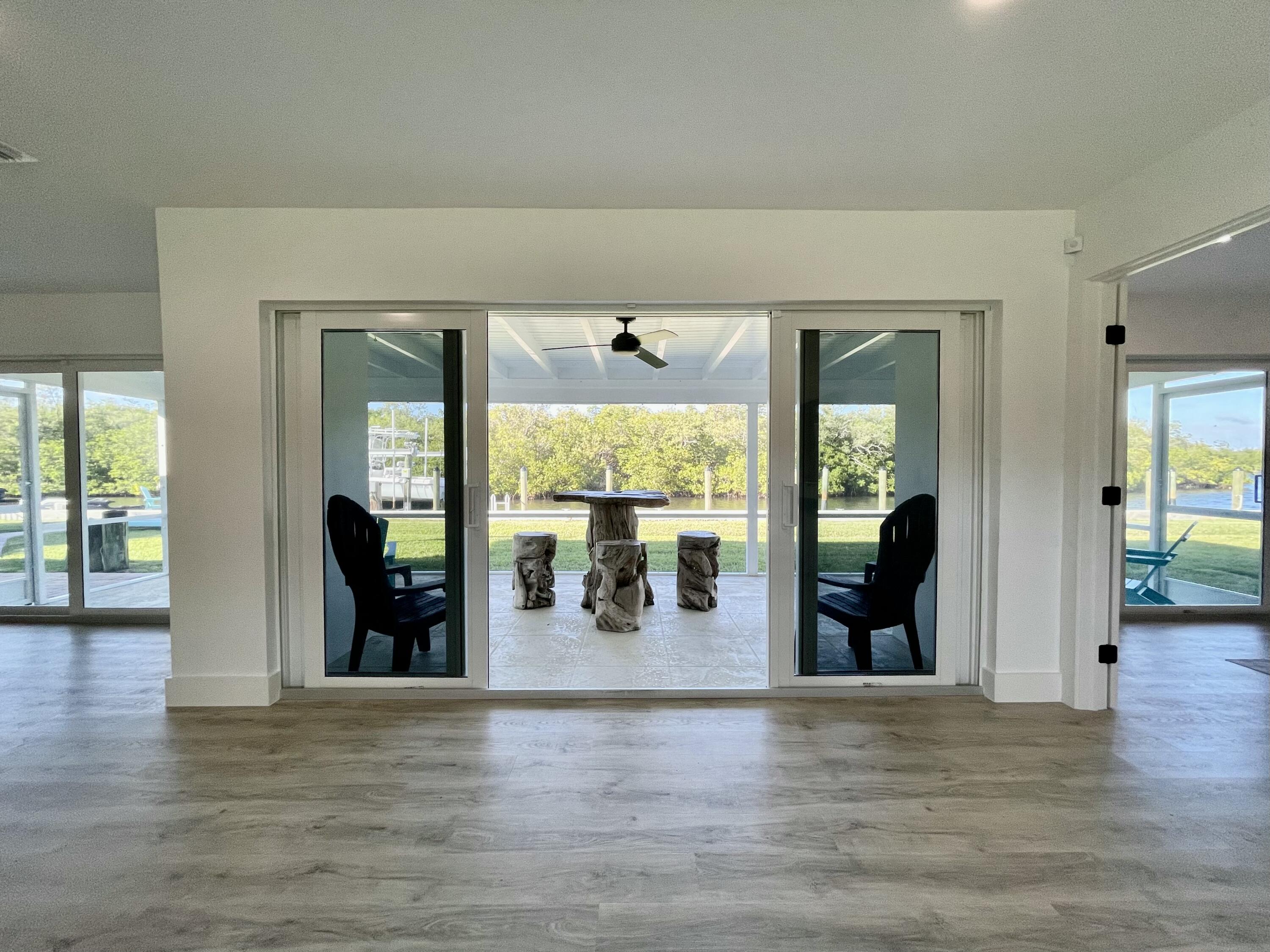 8585 Southeast Palm Street Hobe Sound, FL 33455 - Photo 24 of 43 wooden floor and dining room with wooden floor